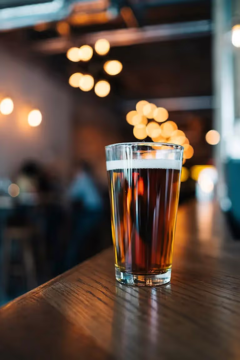 beer on wooden table in front of seating area