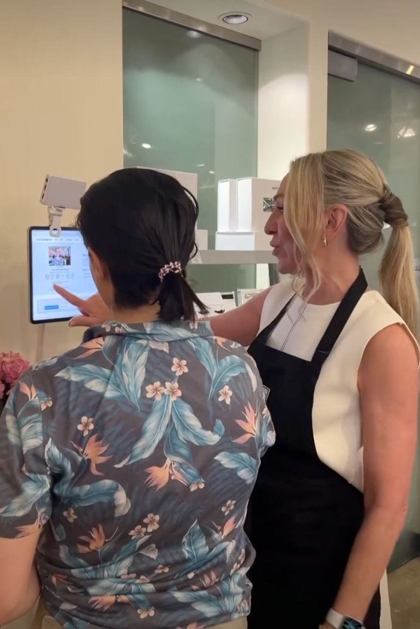 A Skin Authority associate guiding a customer through a Tangent consultation at a partner location
