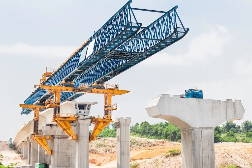 Rail overpass under construction, representing funded infrastructure work continuing through the tightening cycle