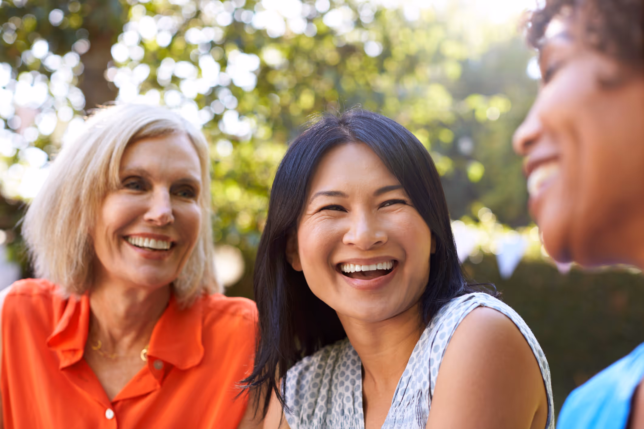 A group of life coaches sitting together, talking and laughing