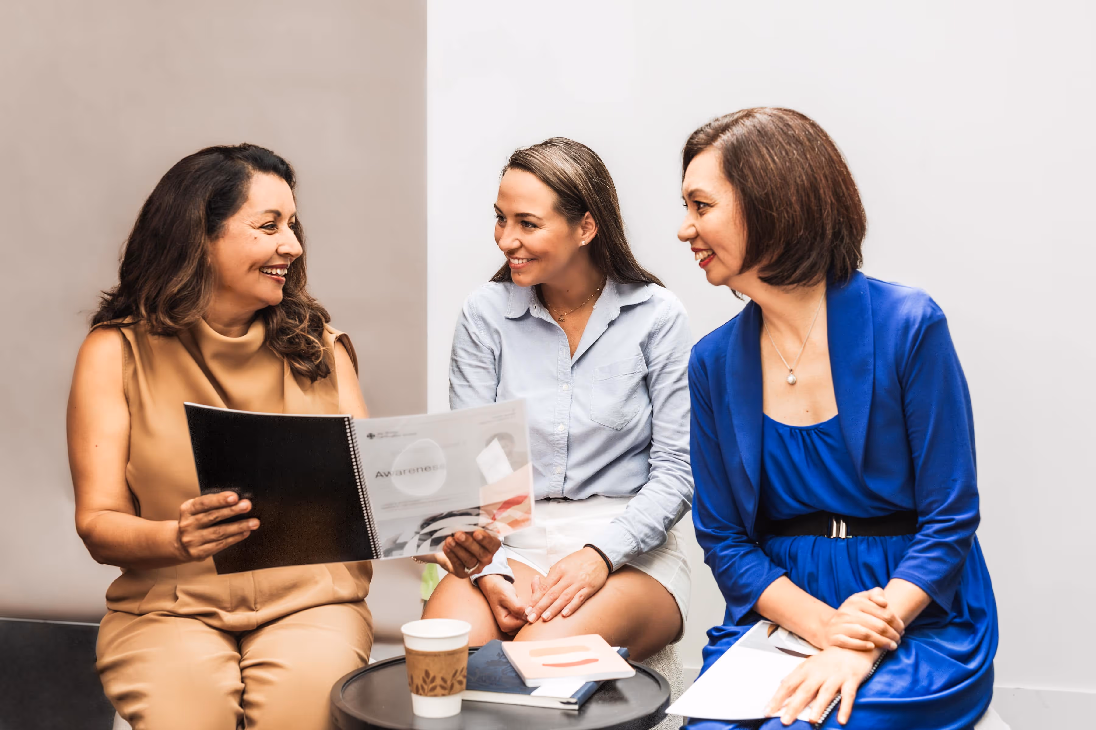 A group of three life coaches sitting together and talking