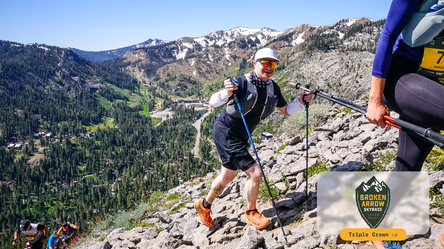 Runners hiking Rocky mountain trail with trekking poles during Broken Arrow Sky Race in Squaw Valley.
