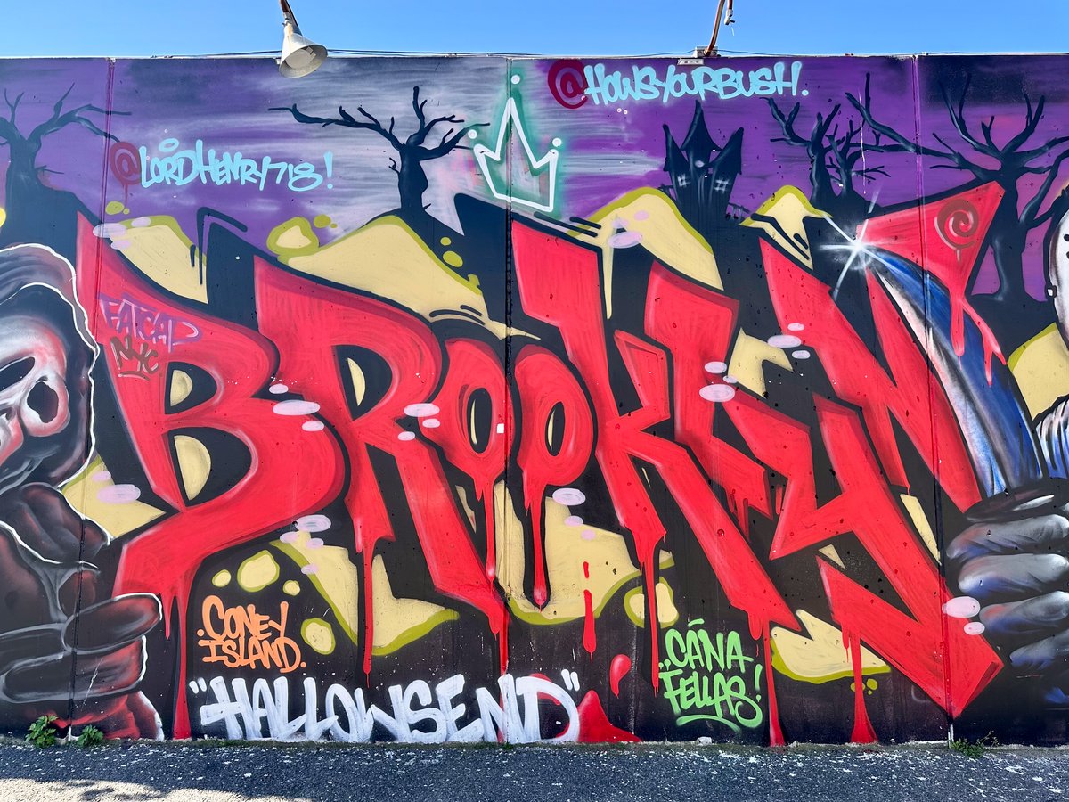 Coney Island graffiti mural reading BROOKLYN in massive red block letters with a Halloween-themed purple background and Coney Island Hallowsend text below
