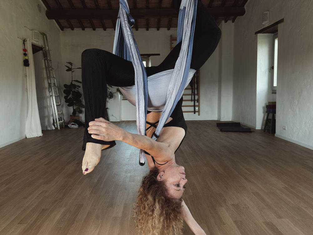Giulia practicing yoga trapeze