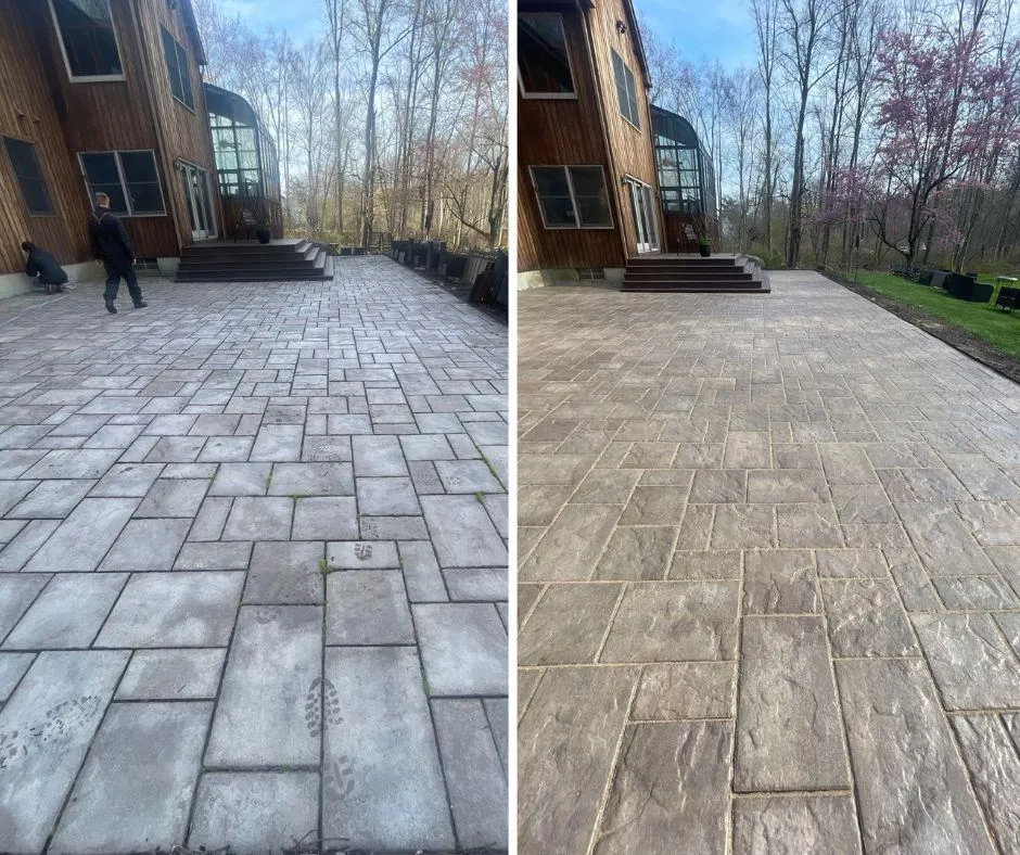 Side-by-side comparison of a large paved patio in front of a wooden house, showing worn and dirty paving stones with footprints on the left and clean, restored paving stones on the right under a partly cloudy sky.