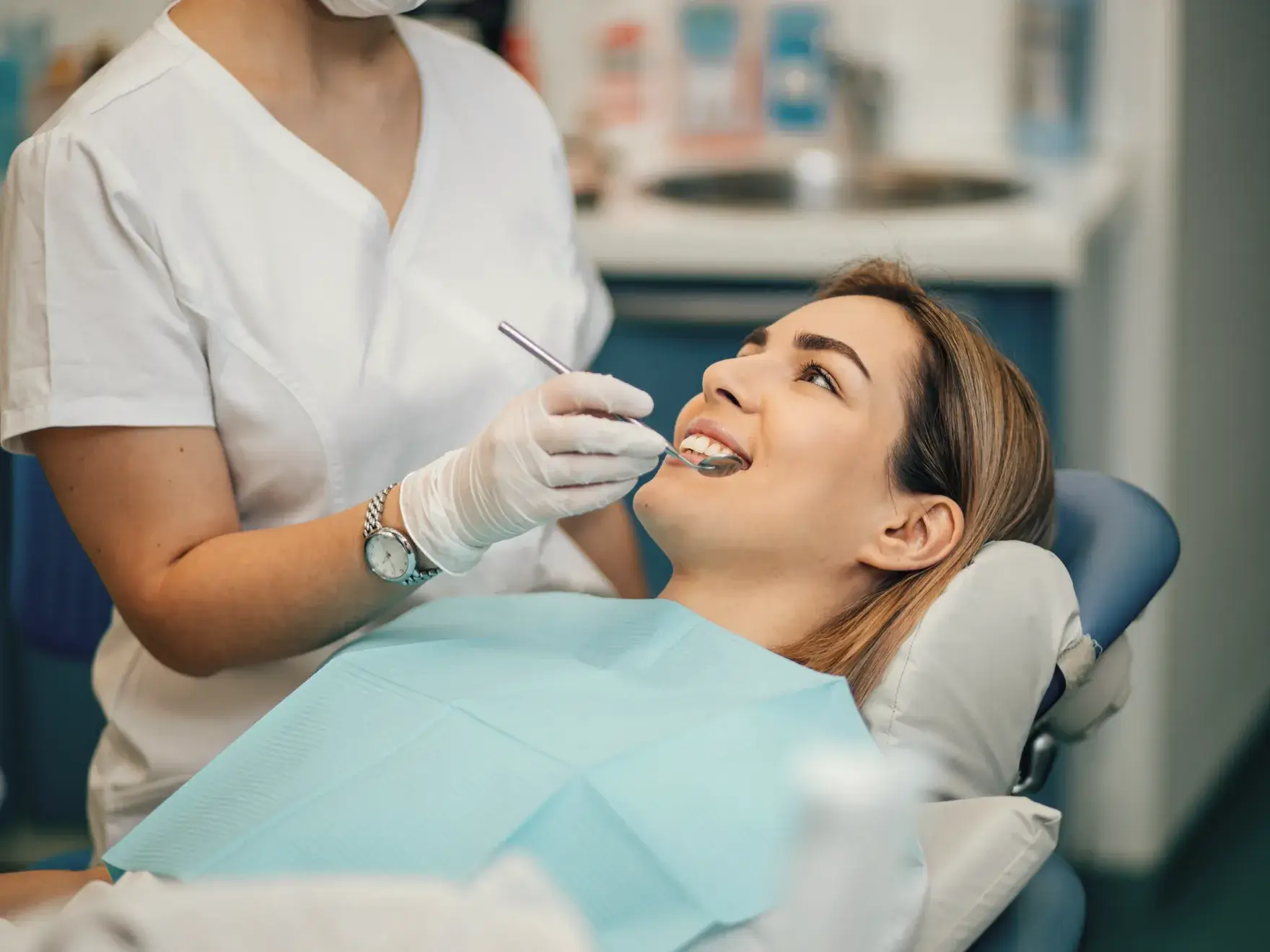 A woman getting her teeth checked by a dentist.