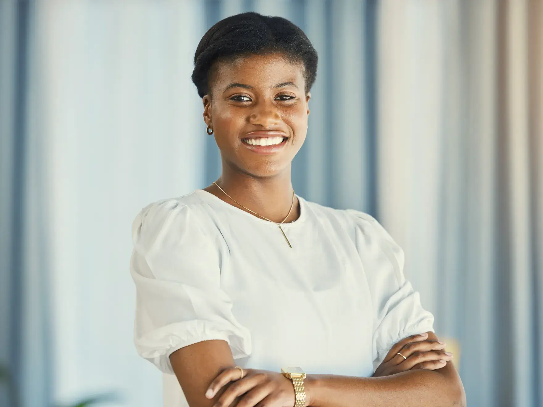 A woman standing with her arms crossed.