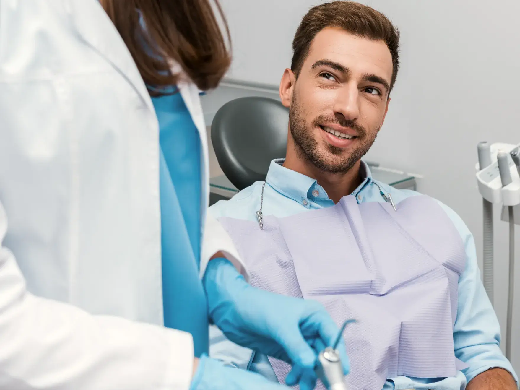 A man in a dentist chair getting his teeth checked.