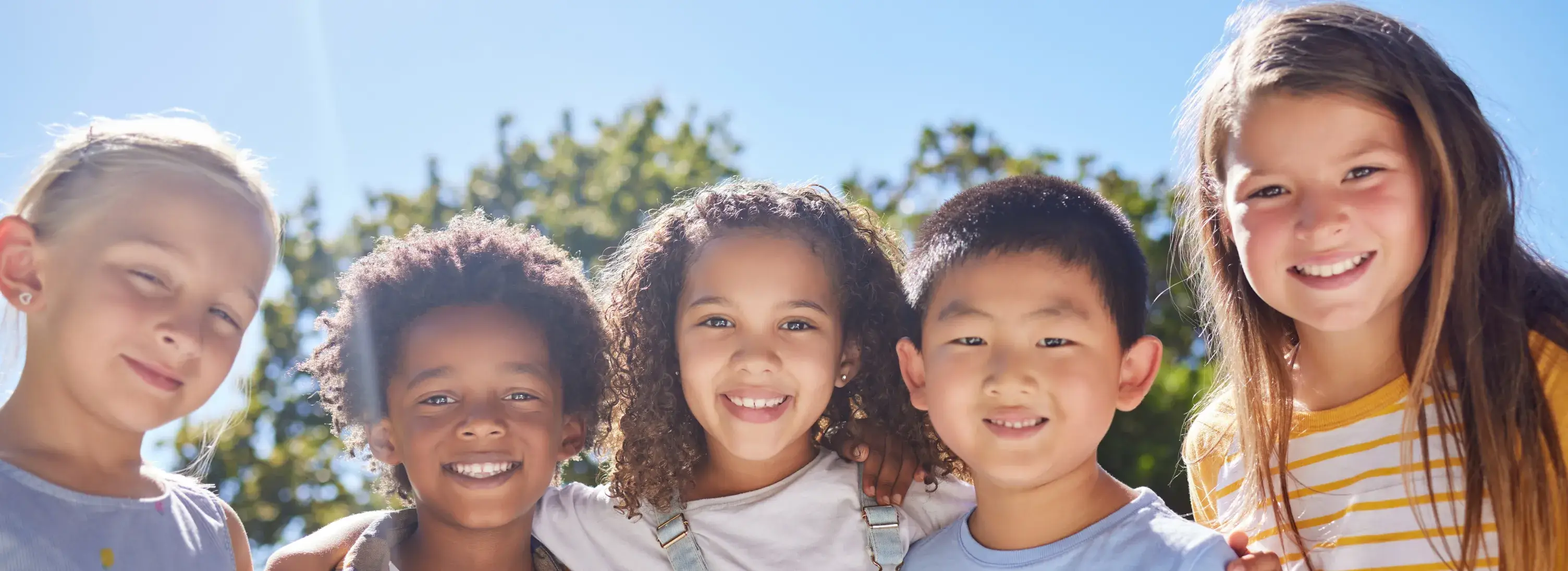 A group of young children standing next to each other.
