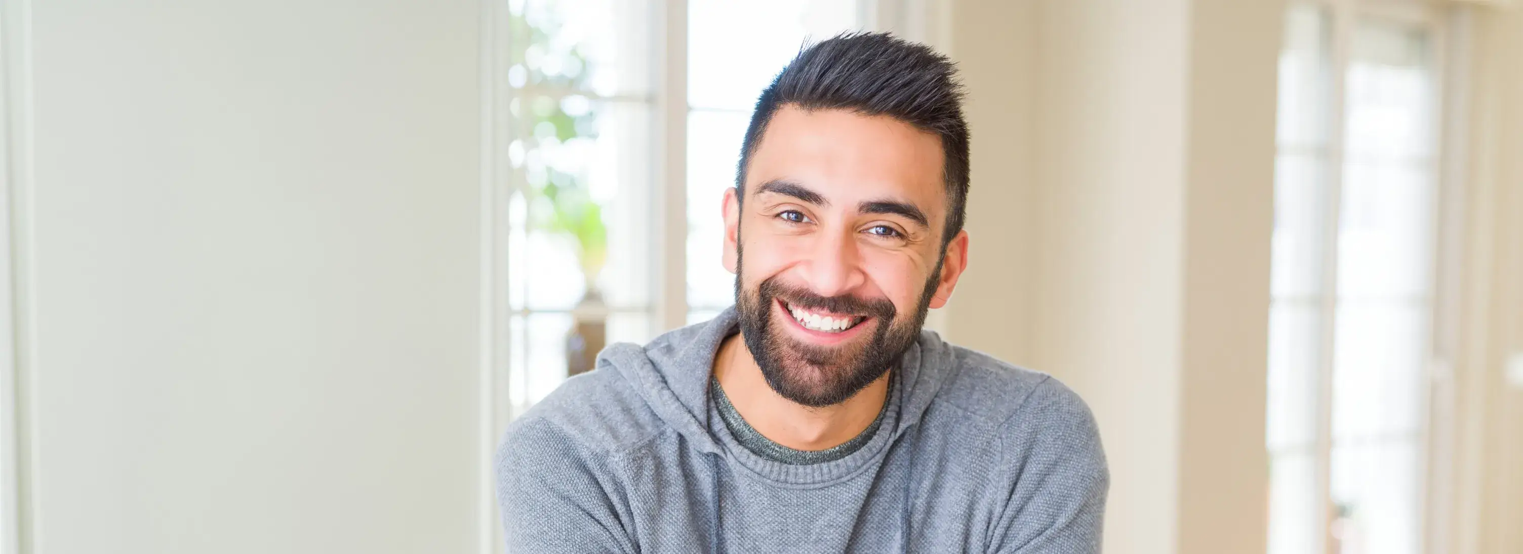 A man with a beard and a gray shirt.