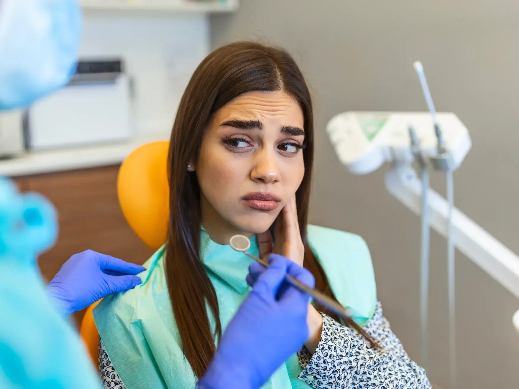 A woman getting her teeth checked by a dentist.