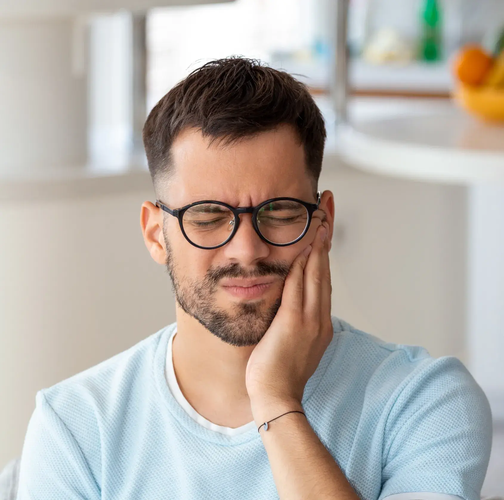 A man with glasses is looking at something.