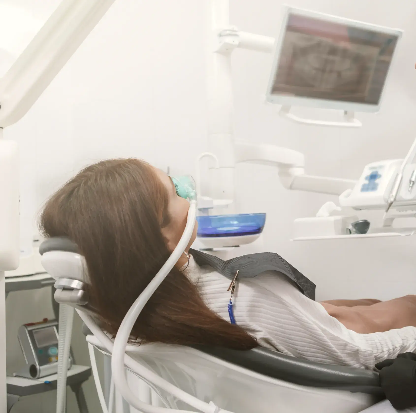 A woman laying down in a dental chair.