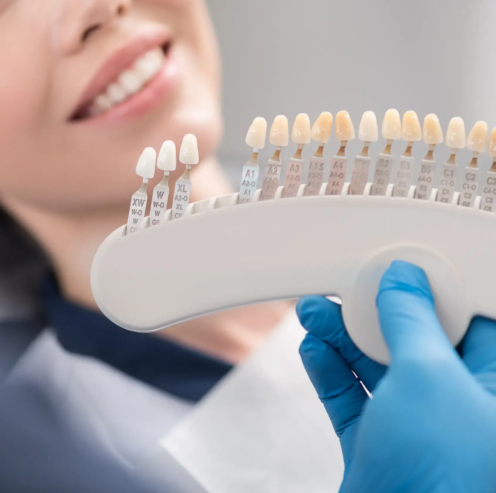 A woman is holding a toothbrush in her hand.