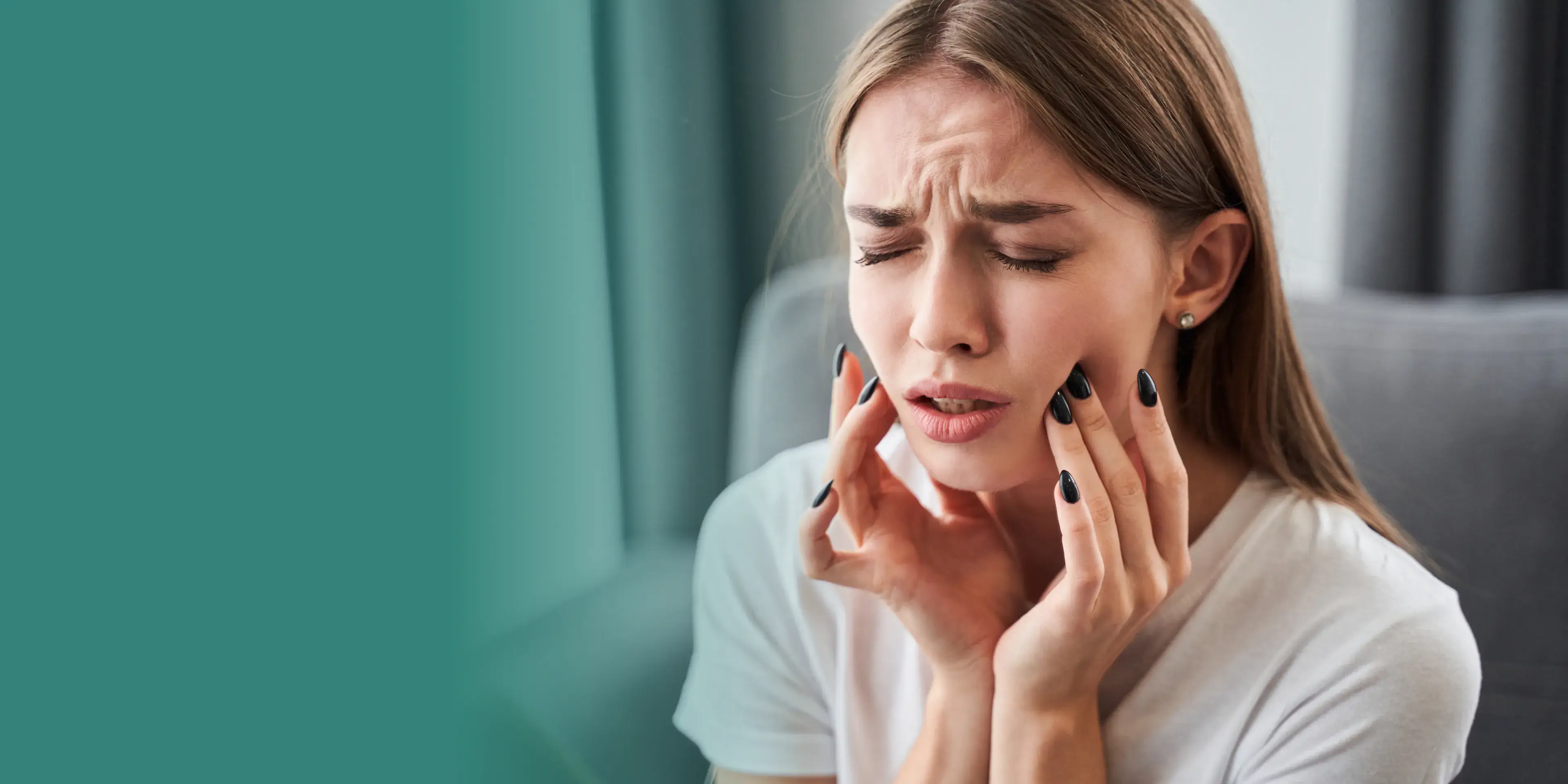 A woman holding her hands to her face.