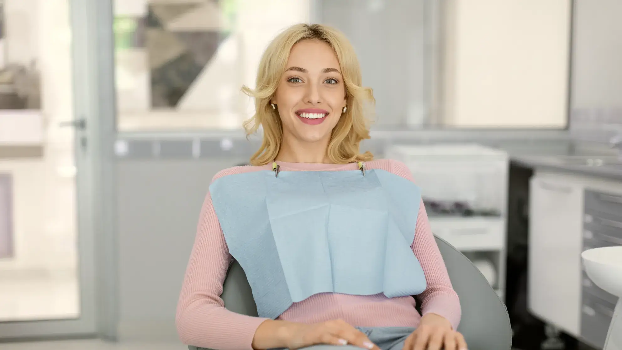 A woman sitting in a chair in an office.