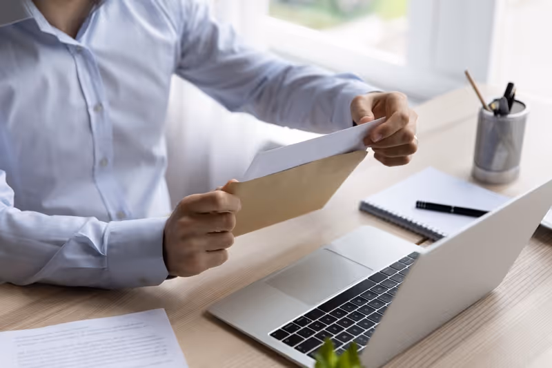 Person working on a computer while reviewing documents related to protecting businesses from CIPA lawsuits and compliance risks