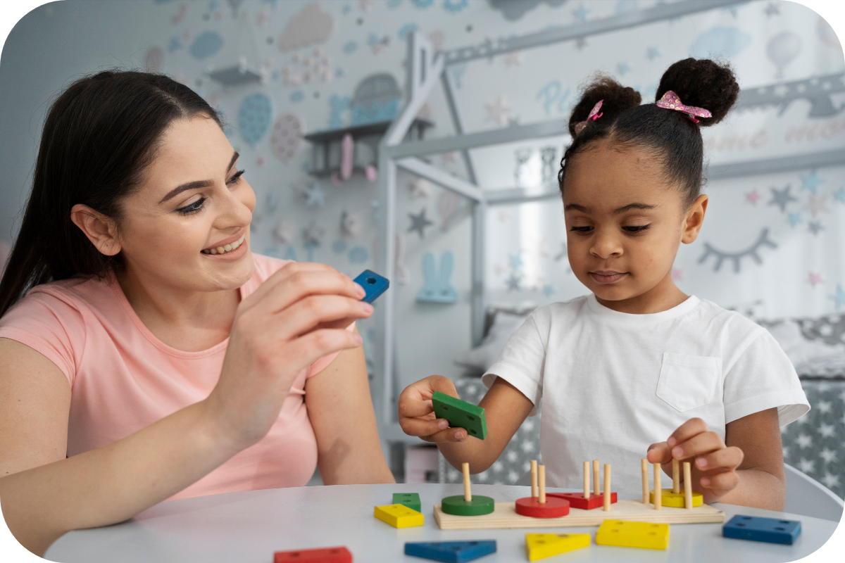 ABA Therapist and a young girl playing with blocks