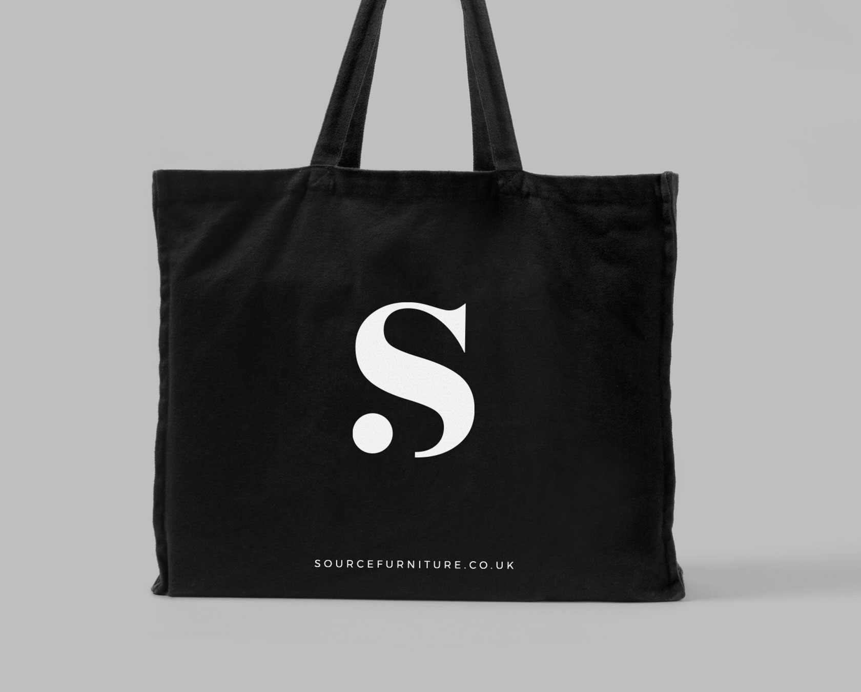 white Source Furniture S on black tote bag