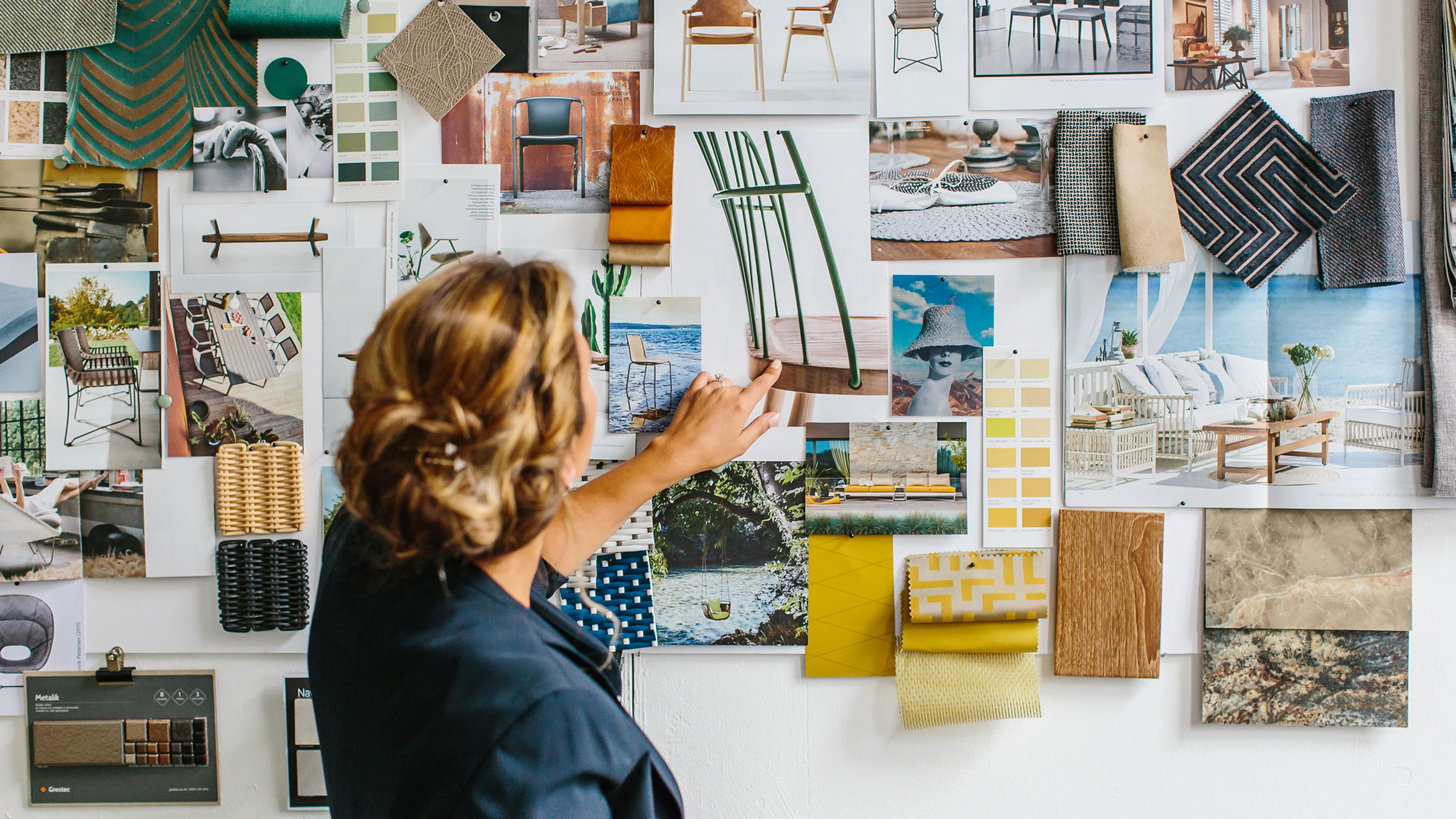 Woman examining furniture moodboard