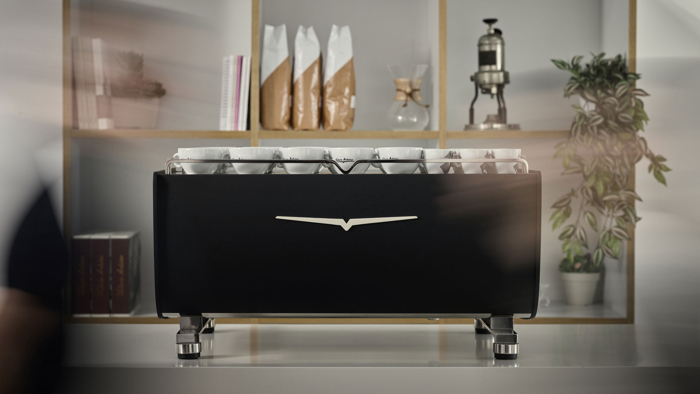 Eagle Core coffee machine on bar with blurred people passing in front