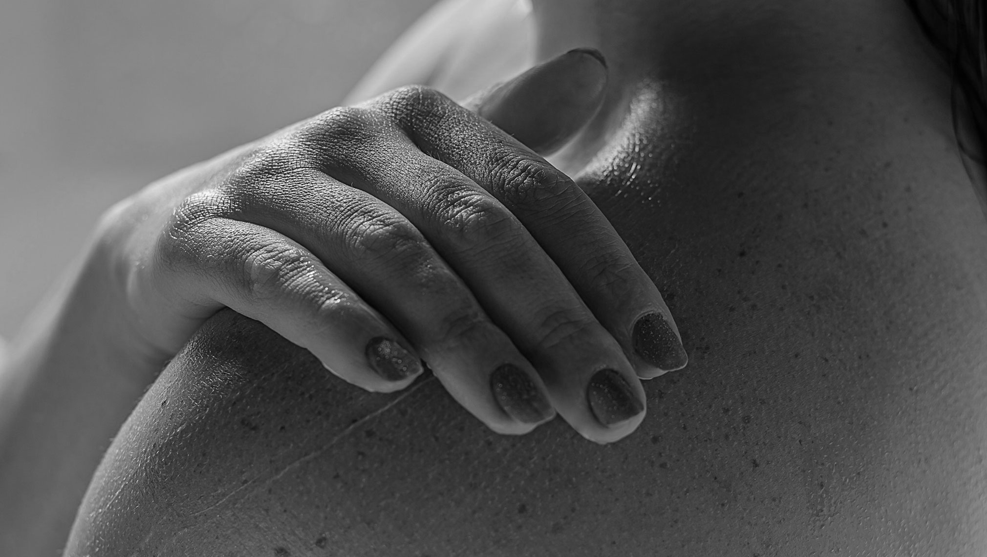 Woman's hand on her shoulder