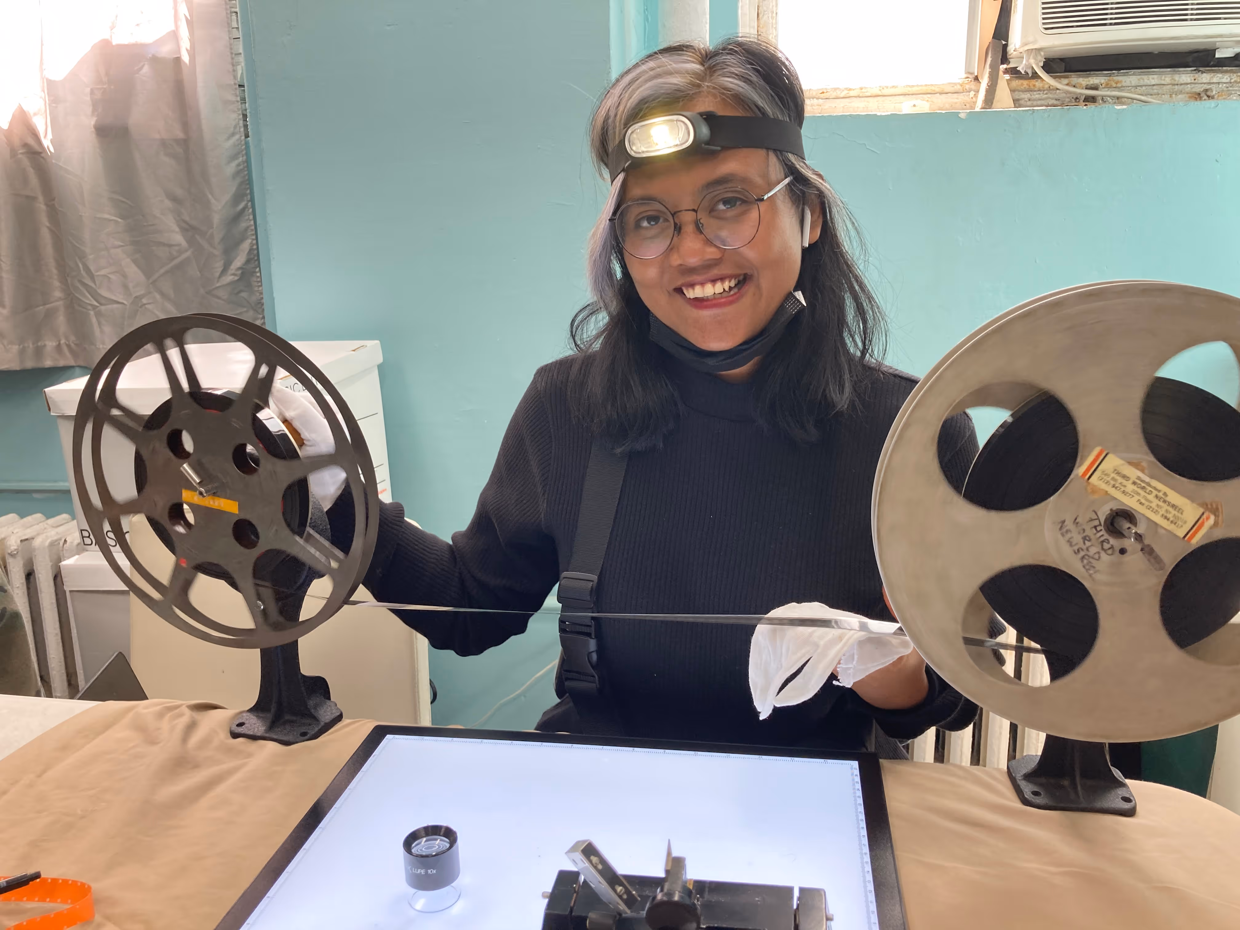 Preservation workflow photo: film reels on inspection table, or drives/storage media. Or a screenshot of the FileMaker catalog.