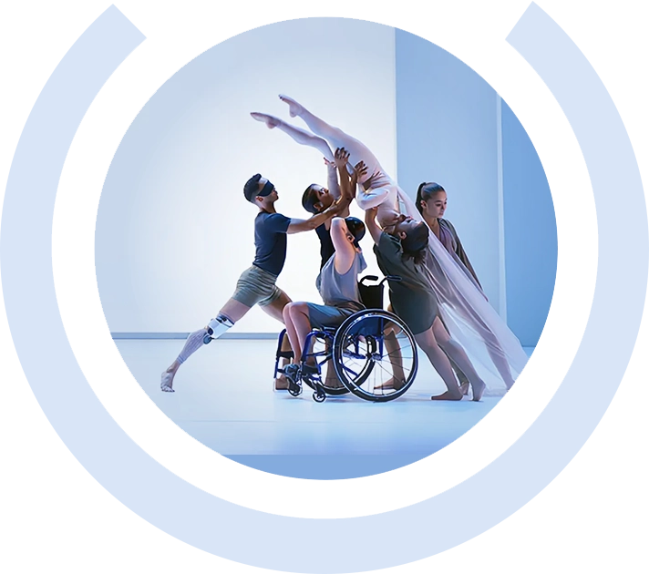 Inclusive dance group lifting a ballerina, featuring performers with visible disabilities.