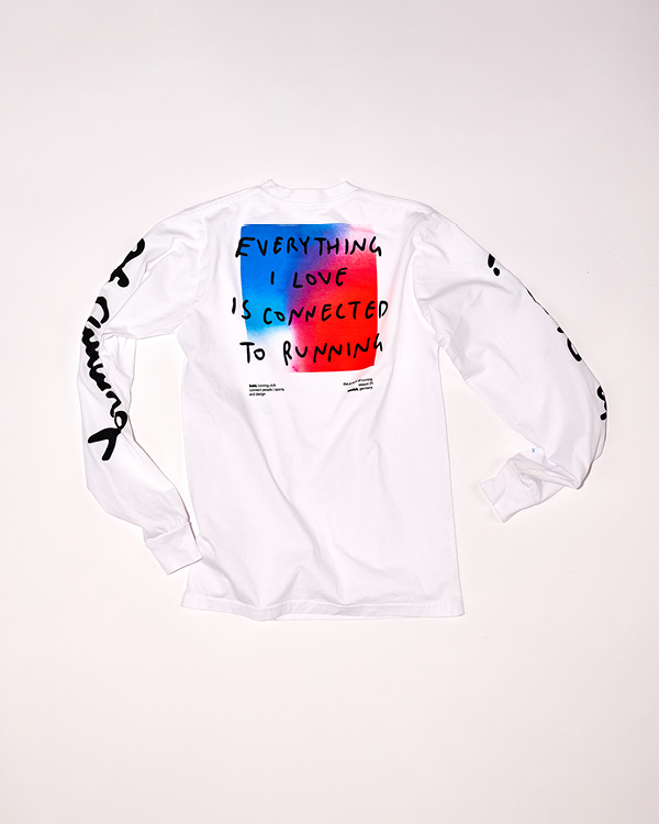 White long-sleeve shirt with colorful text block on the back reading 'EVERYTHING I LOVE IS CONNECTED TO RUNNING' and black script text on both sleeves.