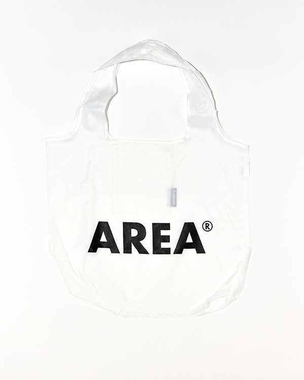 White reusable tote bag with wide handles and the word 'AREA' printed in bold black letters on the front.