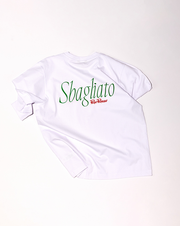 White short-sleeve t-shirt with the word 'Sbagliato' in large green letters and 'Bar Basso' in small red letters on the back.