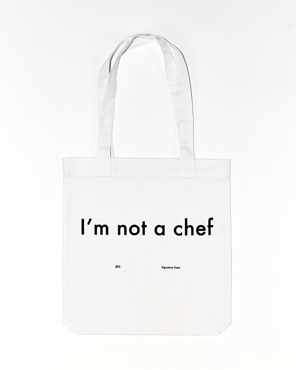 White tote bag with black text reading 'I'm not a chef' on the front.