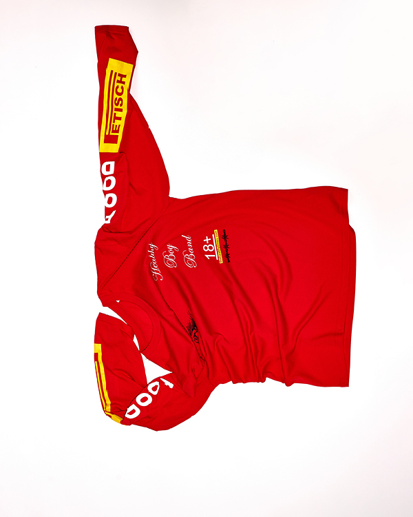 Red long-sleeve shirt with yellow and white text, including 'Fetisch' on the right sleeve and 'Healthy Boy Band 18+' on the chest.