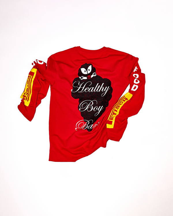 Red long-sleeve shirt with black and white cartoon character and text 'Healthy Boy Band' on the back, and yellow and white graphic designs on sleeves.