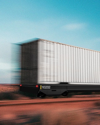 A Parallel Systems autonomous rail vehicle hauling a container at speed