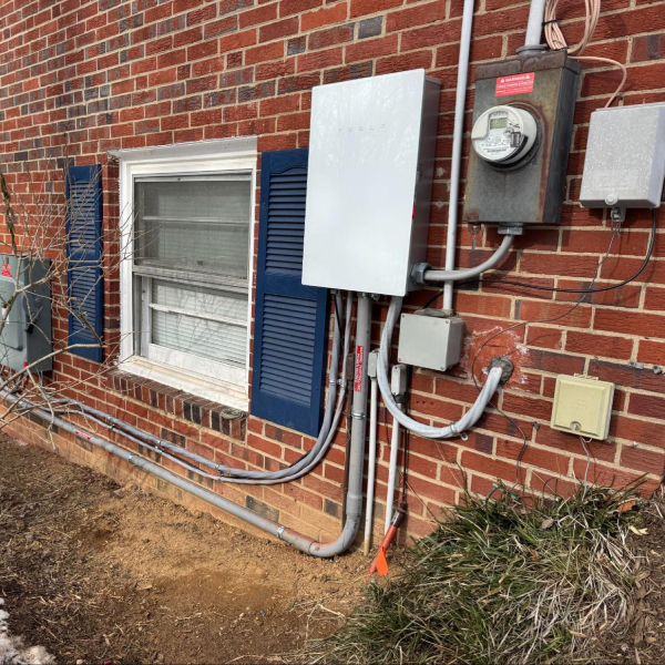 Poor solar installation with uneven wiring and a wall penetration without a junction box