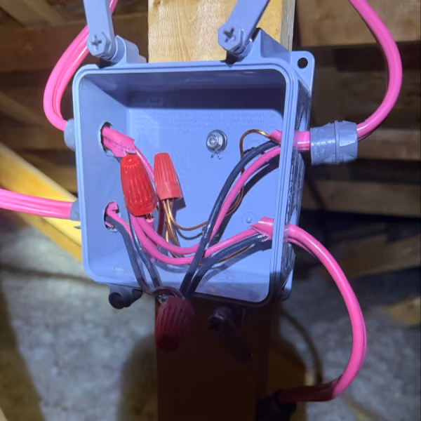 Poor solar junction box wiring with loose connectors, short cables, and disorganized electrical splices