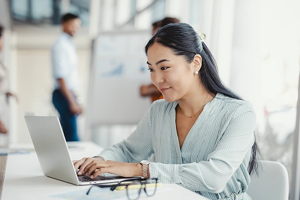 Woman using a laptop.