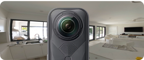 insta 360 camera with a panoramic capture of a house in the background