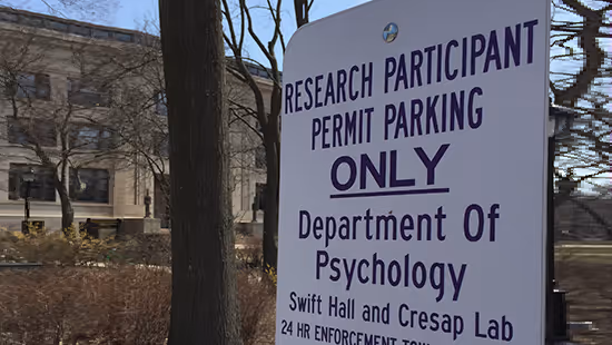 Sign indicating Research Participant Permit Parking Only for Department of Psychology at Swift Hall and Cresap Lab.