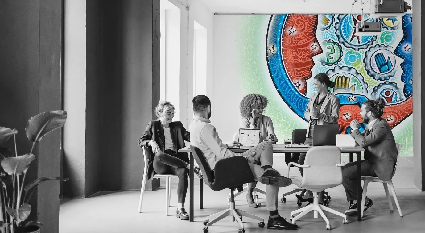 people sitting at a desk in a conference room