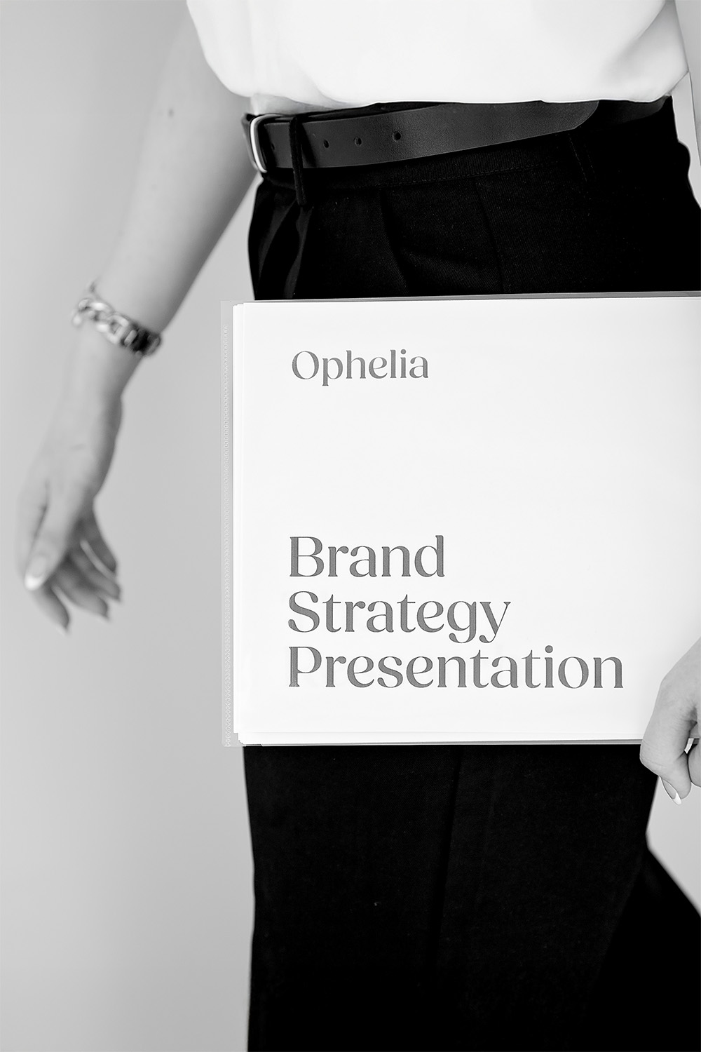 Brand strategy presentation in a folder being held by a freelancer walking to a meeting