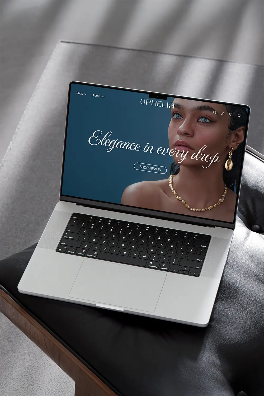 Luxury jewellery website homepage design sitting on a black leather chair with a concrete floor in the background
