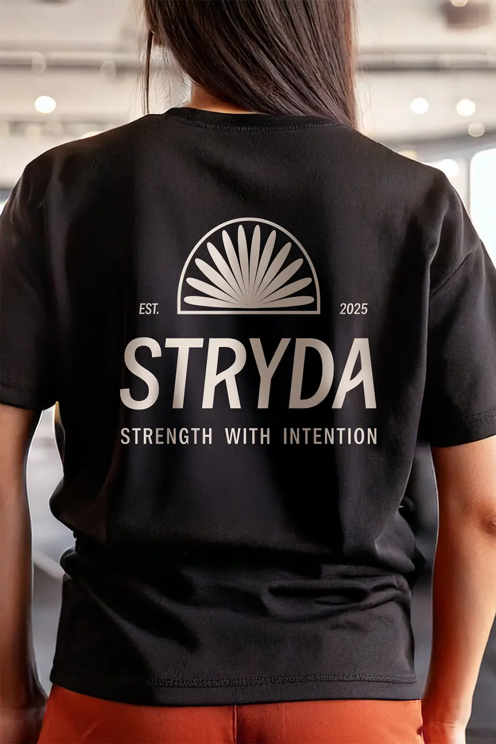 STRYDA brand design case study. STRYDA gym logo on a black t-shirt worn by a woman.