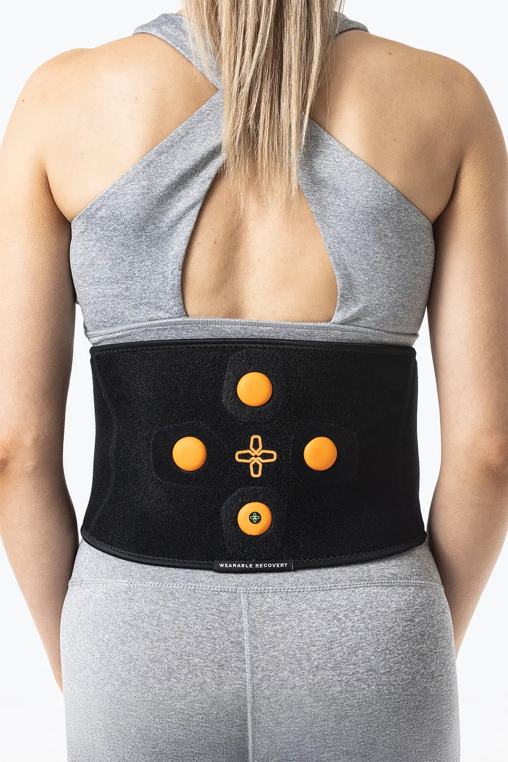 Myovolt brand and website design case study. Young woman wearing a Myovolt Back recovery device.