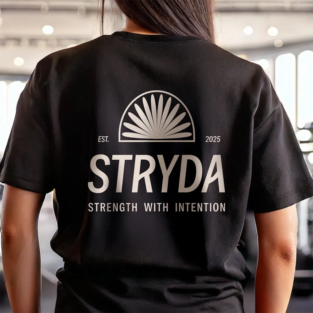STRYDA brand design case study. STRYDA gym logo on a black t-shirt worn by a woman.
