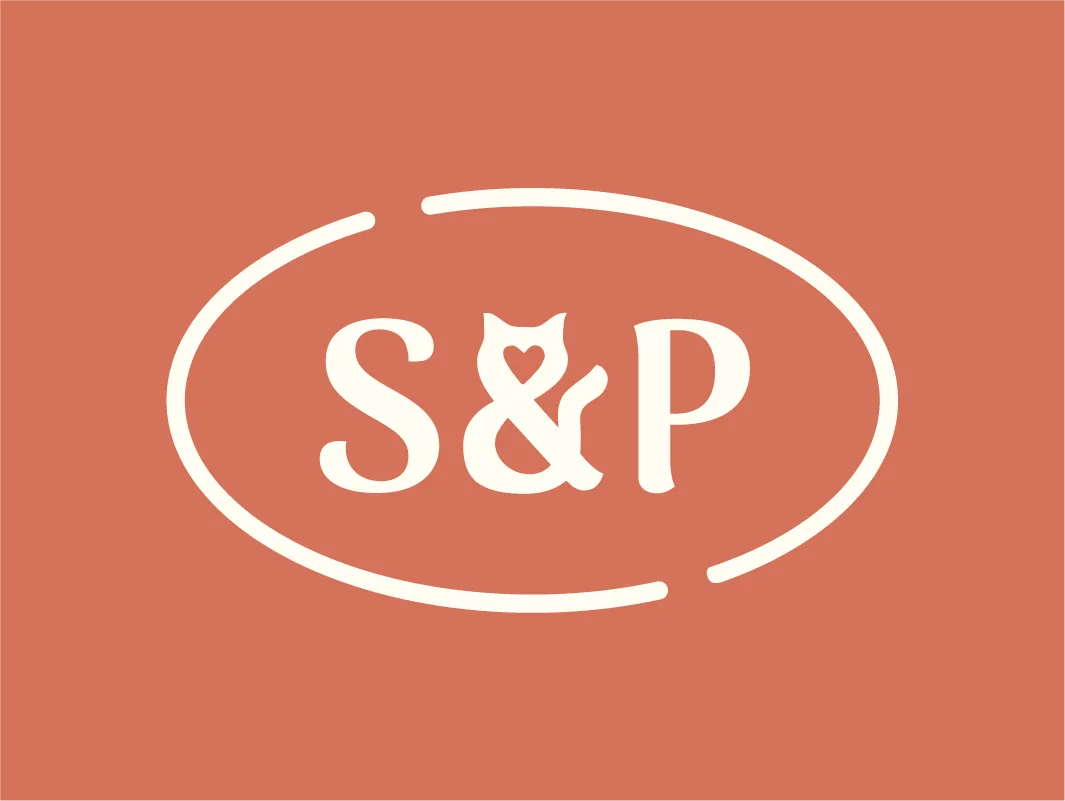 Secondary logo variation for Sip & Purr cat café, featuring "S&P" initials and stylized cat figure with a heart shape in its chest, all enclosed in a broken oval outline on a terracotta background.