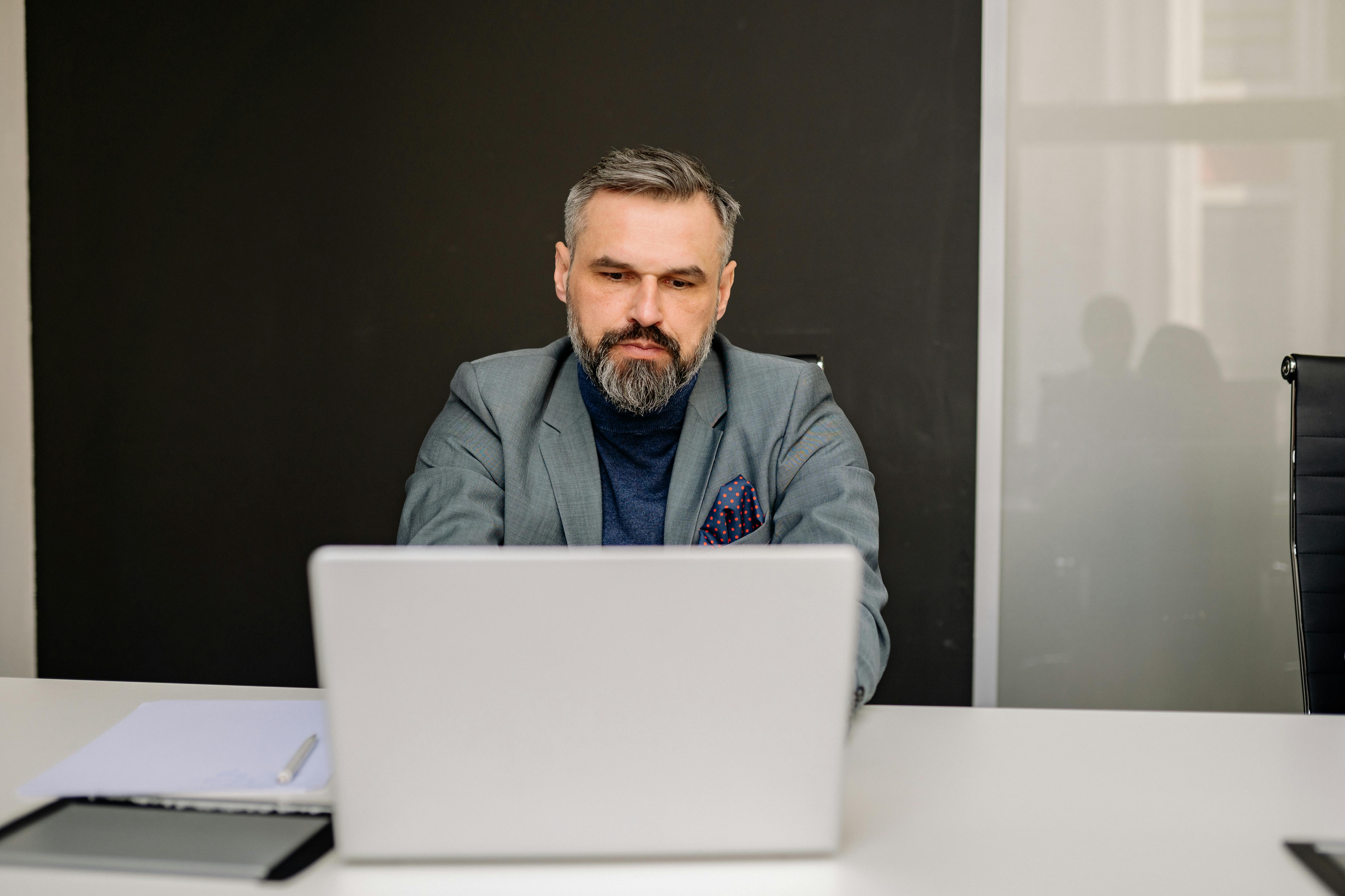 Group of diverse business professionals having a discussion in a modern office, illustrating fractional sales leadership in action, supporting scalable growth without full-time overhead.