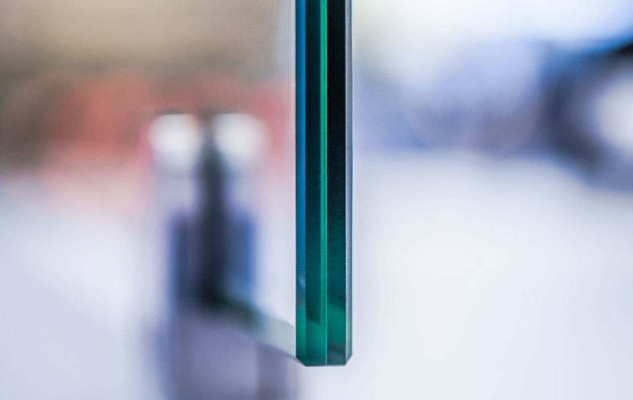 Close-up of two parallel glass panes with a blurred background.