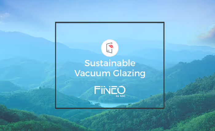 Mountains with green forest under blue sky behind a box reading Sustainable Vacuum Glazing Fineo by AGC.